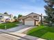 Well-maintained home featuring a two-car garage, brick accents, and manicured lawn at 7351 S Marion St, Centennial, CO 80122
