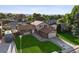Charming home boasts a lush lawn, mature trees, and inviting curb appeal in a desirable neighborhood at 7351 S Marion St, Centennial, CO 80122