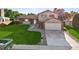 Charming home with well-maintained lawn, brick accents, attached garage, and inviting front entrance at 7351 S Marion St, Centennial, CO 80122