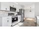 Bright kitchen features stainless steel appliances and white cabinets at 7351 S Marion St, Centennial, CO 80122
