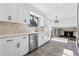 Bright kitchen features white cabinets, stone backsplash, and stainless steel appliances at 7351 S Marion St, Centennial, CO 80122