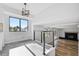 Inviting living room with a decorative light fixture and black metal railing at 7351 S Marion St, Centennial, CO 80122
