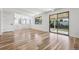 Open-concept living area featuring hardwood floors, modern lighting, sliding glass doors, and a staircase at 7351 S Marion St, Centennial, CO 80122