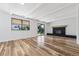 Open living room features a brick fireplace and ample natural light at 7351 S Marion St, Centennial, CO 80122
