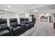 Finished basement with theater seating, wet bar, and carpeted floors at 775 Poppywood Dr, Highlands Ranch, CO 80126