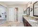 Spacious bathroom featuring double sinks, granite countertops, and tile flooring at 775 Poppywood Dr, Highlands Ranch, CO 80126