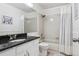Clean bathroom featuring a shower-tub combo and a dark granite countertop sink at 775 Poppywood Dr, Highlands Ranch, CO 80126