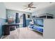 Bright bedroom featuring a bunk bed, desk, ceiling fan, and a large window letting in natural light at 775 Poppywood Dr, Highlands Ranch, CO 80126