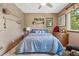 Bedroom featuring paddle oars and water themed art, carpeting, and large window at 775 Poppywood Dr, Highlands Ranch, CO 80126