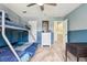 Spacious bedroom featuring a bunk bed, dresser, and light gray carpeted floors at 775 Poppywood Dr, Highlands Ranch, CO 80126