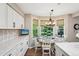 Cozy breakfast nook with bay window, white table set, and window treatments at 775 Poppywood Dr, Highlands Ranch, CO 80126