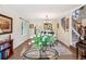 Dining area with hard wood floors, decorative lighting, and stairway access at 775 Poppywood Dr, Highlands Ranch, CO 80126