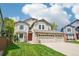 Charming two-story home features a three-car garage, red door, and well-manicured lawn at 775 Poppywood Dr, Highlands Ranch, CO 80126