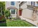 Inviting home exterior boasts a charming front yard with manicured lawn and decorative landscaping at 775 Poppywood Dr, Highlands Ranch, CO 80126