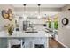 Open kitchen with white cabinets, stainless steel appliances, and a breakfast nook at 775 Poppywood Dr, Highlands Ranch, CO 80126