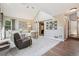 Open concept living room features vaulted ceilings, fireplace, and large windows for ample natural light at 775 Poppywood Dr, Highlands Ranch, CO 80126