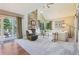 Bright living room features vaulted ceilings, a stone fireplace, and access to an outdoor patio at 775 Poppywood Dr, Highlands Ranch, CO 80126