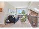 Bright living room with comfortable seating, a guitar, and a large window offering a pleasant view at 775 Poppywood Dr, Highlands Ranch, CO 80126
