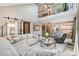 Open-concept living room boasts high ceilings, modern furniture, and seamless flow to the kitchen at 775 Poppywood Dr, Highlands Ranch, CO 80126