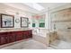 Bright bathroom with double vanity, soaking tub, and glass-enclosed shower, offering a luxurious experience at 775 Poppywood Dr, Highlands Ranch, CO 80126