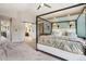 Bright main bedroom with a four-poster bed, ensuite bathroom, and modern finishes creates a serene retreat at 775 Poppywood Dr, Highlands Ranch, CO 80126