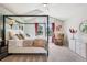 Comfortable main bedroom with a four-poster bed, ceiling fan, and sitting area, perfect for relaxation at 775 Poppywood Dr, Highlands Ranch, CO 80126