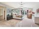 Spacious main bedroom featuring a four-poster bed, vaulted ceilings, and ample natural light from large windows at 775 Poppywood Dr, Highlands Ranch, CO 80126