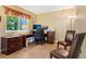 Functional home office with ample desk space, comfortable seating, and large windows for a productive environment at 775 Poppywood Dr, Highlands Ranch, CO 80126