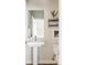 Stylish half-bathroom features a pedestal sink, framed artwork, and an adjacent toilet providing convenience at 3145 W 19Th Ave, Denver, CO 80204