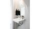 Modern half bathroom features a sleek sink, mirror, and stylish fixtures in a minimalist design at 3145 W 19Th Ave, Denver, CO 80204