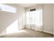 Sunlit bedroom with neutral carpet, sheer curtains, and a minimalist design at 3145 W 19Th Ave, Denver, CO 80204