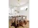 Bright dining room with hardwood floors, modern lighting, and a rustic wood table for stylish gatherings at 3145 W 19Th Ave, Denver, CO 80204