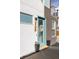 Inviting front entrance featuring a stylish teal door, decorative wreath, and potted plants for curb appeal at 3145 W 19Th Ave, Denver, CO 80204