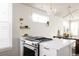 Well-equipped kitchen with a stainless steel stove, white countertops, and open shelving for a modern feel at 3145 W 19Th Ave, Denver, CO 80204