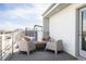 Outdoor patio area with comfortable seating and a view of the city skyline at 3145 W 19Th Ave, Denver, CO 80204