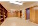 Finished basement area with paneled walls and built-in shelving at 2885 S Gilpin St, Denver, CO 80210