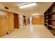Basement area with paneled walls, built-in shelving and access to stairs at 2885 S Gilpin St, Denver, CO 80210
