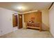 Unfinished basement features pegboard, utility table and door opening to additional room at 2885 S Gilpin St, Denver, CO 80210