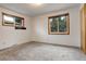 Neutral bedroom featuring carpeting, large windows with wooden trim, and a closet at 2885 S Gilpin St, Denver, CO 80210
