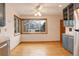 Bright dining area with large windows, ceiling fan, and hardwood floors at 2885 S Gilpin St, Denver, CO 80210