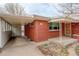 Charming single-story red brick home with a covered car port and well-maintained yard at 2885 S Gilpin St, Denver, CO 80210