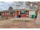 Exterior view of brick home with patio and drought-tolerant landscaping at 2885 S Gilpin St, Denver, CO 80210