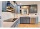 Updated kitchen with blue cabinets, stainless steel appliances, and modern countertops at 2885 S Gilpin St, Denver, CO 80210