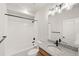 Bathroom features a granite-topped sink, and a shower with white tiling, combining style and functionality at 8777 Whiteclover St, Littleton, CO 80125