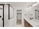 Bathroom featuring a glass shower and granite topped vanity at 8777 Whiteclover St, Littleton, CO 80125