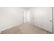 Carpeted bedroom with closet and access to another room at 8777 Whiteclover St, Littleton, CO 80125