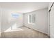 Bright bedroom featuring neutral carpet, fresh white paint and two sunny windows at 8777 Whiteclover St, Littleton, CO 80125