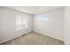 Bedroom with neutral carpet, two windows, and fresh white paint at 8777 Whiteclover St, Littleton, CO 80125