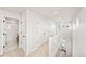 Upstairs hallway with linen closet and a glimpse into the bathroom at 8777 Whiteclover St, Littleton, CO 80125