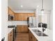Stylish kitchen with stainless steel appliances, island, and ample counter space at 8777 Whiteclover St, Littleton, CO 80125